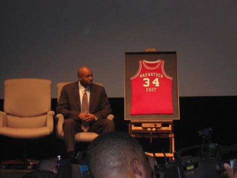 Tony Smith sits on the stage as his newly retired Wauwatosa East jersey is exhibited. That same night, Devin Harris was honored as his jersey was also retired.